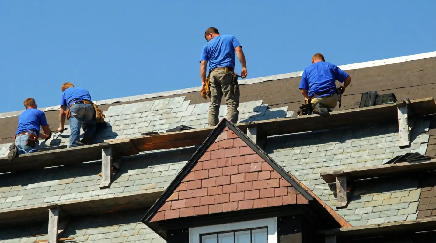Roof replacement in progress with a team of professional contractors installing new shingles on a residential home in ,